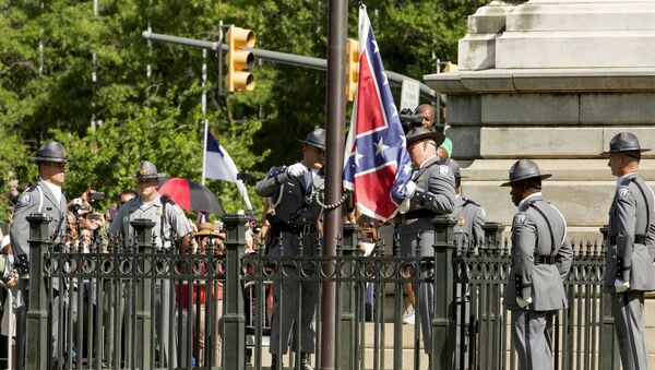 The Confederate battle flag is permanently removed from the South Carolina statehouse grounds during a ceremony in Columbia, South Carolina, July, 10, 2015 - Sputnik International