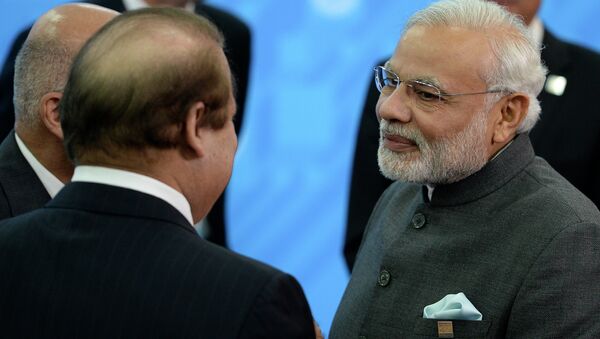 Indian Prime Minister Narendra Modi, right, speaks to Prime Minister of Pakistan Muhammad Nawaz Sharif, back to a camera, during the SCO (Shanghai Cooperation Organization) summit in Ufa, Russia, Friday, July 10, 2015 - Sputnik International