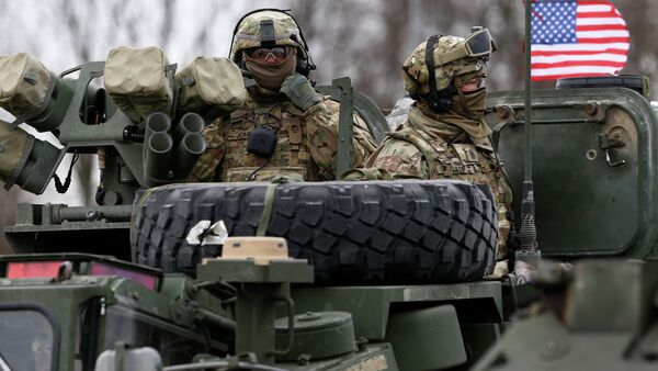 Members of US Army’s 2nd Cavalry Regiment ride on an armored vehicle during the ''Dragoon Ride'' military exercise in Salociai some 178 kms (110 miles) north of the capital Vilnius, Lithuania, Monday, March 23, 2015 - Sputnik International