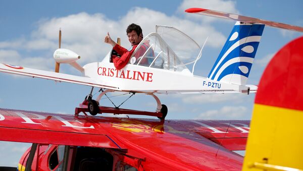 Pilot Hugues Duval in his twin-engined Cri-Cri, one of the world's smallest electrical planes, waits to take off from an old Broussard aircraft, on which it is attached to, during a flying display at the 51st Paris Air Show at Le Bourget airport near Paris, June 19, 2015 - Sputnik International