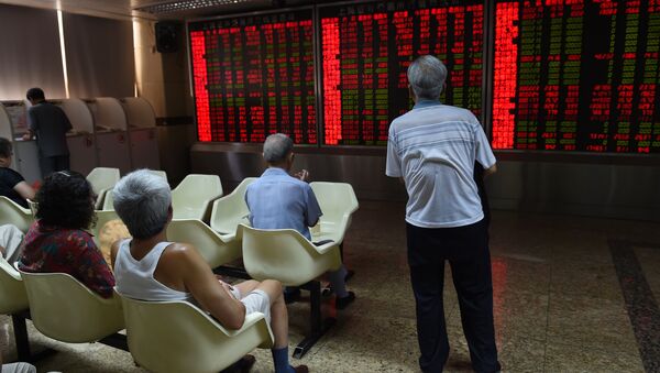 Investors look at a board showing stock market movements at a securities company in Beijing on July 10, 2015 - Sputnik International