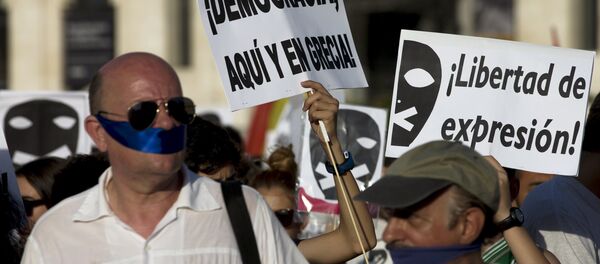 Demonstrators with their mouths taped attend a protest against Spanish government's new security law in central Madrid, Spain, June 30, 2015 Demonstrators with their mouths taped attend a protest against Spanish government's new security law in central Madrid, Spain, June 30, 2015 - Sputnik International