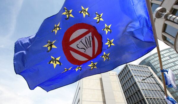 A flag which says stop and has euro money signs in the EU stars flaps in the wind during a protest march in solidarity with Greece in the center of Brussels on Sunday, June 21, 2015 A flag which says stop and has euro money signs in the EU stars flaps in the wind during a protest march in solidarity with Greece in the center of Brussels on Sunday, June 21, 2015 - Sputnik International