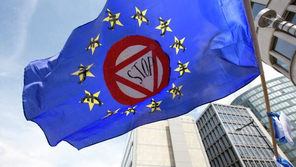 A flag which says stop and has euro money signs in the EU stars flaps in the wind during a protest march in solidarity with Greece in the center of Brussels on Sunday, June 21, 2015 - Sputnik International