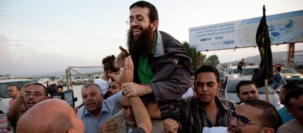 Palestinian Khader Adnan, center, is greeted by Palestinians after his release from an Israeli prison in the West Bank village of Arrabeh near Jenin, Sunday, July 12, 2015 Palestinian Khader Adnan, center, is greeted by Palestinians after his release from an Israeli prison in the West Bank village of Arrabeh near Jenin, Sunday, July 12, 2015 - Sputnik International