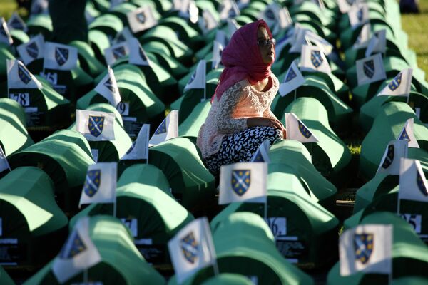 A Bosnian girl prays next to a coffin containing the remains of her relative perished in the Srebrenica massacre, during a funeral ceremony for the 136 victims at the Potocari memorial complex near Srebrenica, 150 kilometers (94 miles) northeast of Sarajevo, Bosnia and Herzegovina, Saturday, July 11, 2015 A Bosnian girl prays next to a coffin containing the remains of her relative perished in the Srebrenica massacre, during a funeral ceremony for the 136 victims at the Potocari memorial complex near Srebrenica, 150 kilometers (94 miles) northeast of Sarajevo, Bosnia and Herzegovina, Saturday, July 11, 2015 - Sputnik International