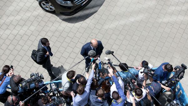 European Commissioner for the Economy Pierre Moscovici, center, speak with the media as he arrives for a meeting of eurozone finance ministers in Brussels on Thursday, June 25, 2015 - Sputnik International