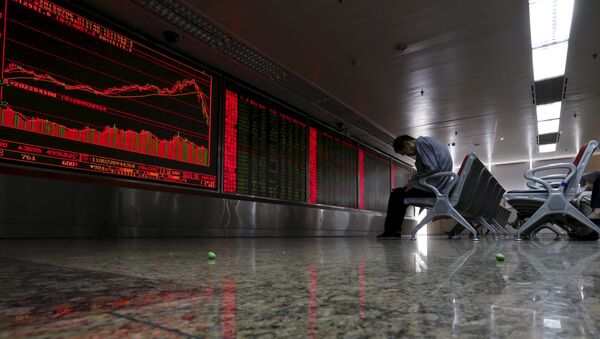 An investor takes notes as he watches a board showing stock prices at a brokerage office in Beijing, China, in this July 6, 2015 file photo - Sputnik International