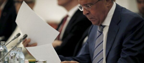 Russian Foreign Minister Sergei Lavrov reads documents during a meeting with foreign ministers and delegations from Germany, France, China, Britain, the U.S. and the European Union at a hotel in Vienna, Austria July 13, 2015 Russian Foreign Minister Sergei Lavrov reads documents during a meeting with foreign ministers and delegations from Germany, France, China, Britain, the U.S. and the European Union at a hotel in Vienna, Austria July 13, 2015 - Sputnik International