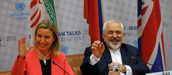 High Representative of the European Union for Foreign Affairs and Security Policy Federica Mogherini and Iranian Foreign Minister Mohammad Javad Zarif (R) react during a plenary session at the United Nations building in Vienna, Austria July 14, 2015. - Sputnik International