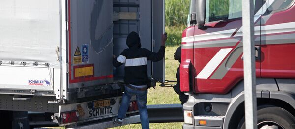 A migrant goes inside a lorry to attempt to cross the English Channel, in Calais, northern France, Wednesday, June 24, 2015. A migrant goes inside a lorry to attempt to cross the English Channel, in Calais, northern France, Wednesday, June 24, 2015. - Sputnik International