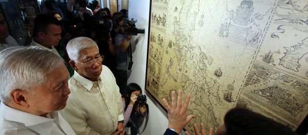 Philippine Foreign Affairs Secretary Albert del Rosario, left, and Defense Secretary Voltaire Gazmin, center, listen during a cartographic exhibit entitled “Historical Truths and Lies: Scarborough Shoal in Ancient Maps.” Philippine Foreign Affairs Secretary Albert del Rosario, left, and Defense Secretary Voltaire Gazmin, center, listen during a cartographic exhibit entitled “Historical Truths and Lies: Scarborough Shoal in Ancient Maps.” - Sputnik International