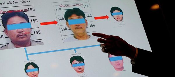An official from Thailand's Department of Special Investigation points at a chart showing suspects in a human trafficking ring during a news conference in Bangkok, Thailand, Wednesday, July 1, 2015. An official from Thailand's Department of Special Investigation points at a chart showing suspects in a human trafficking ring during a news conference in Bangkok, Thailand, Wednesday, July 1, 2015. - Sputnik International
