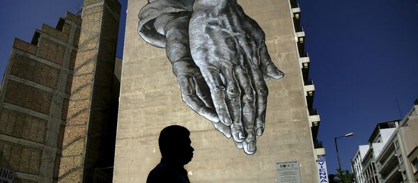 A pedestrian walks through empty streets by a mural in Athens, Greece A pedestrian walks through empty streets by a mural in Athens, Greece - Sputnik International
