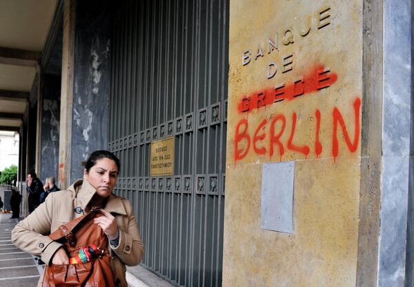 A woman passes by the Bank of Greece headquarters where 'Greece' was changed to 'Berlin' during a 24-hour general strike in Athens on February 7, 2012. A woman passes by the Bank of Greece headquarters where 'Greece' was changed to 'Berlin' during a 24-hour general strike in Athens on February 7, 2012. - Sputnik International