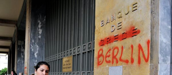 A woman passes by the Bank of Greece headquarters where 'Greece' was changed to 'Berlin' during a 24-hour general strike in Athens on February 7, 2012. A woman passes by the Bank of Greece headquarters where 'Greece' was changed to 'Berlin' during a 24-hour general strike in Athens on February 7, 2012. - Sputnik International
