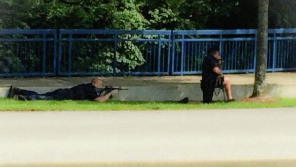 In this image made from video and released by WRCB-TV, authorities work an active shooting scene on amincola highway near the Naval Reserve Center, in Chattanooga, Tenn. on Thursday, July 16, 2015 - Sputnik International