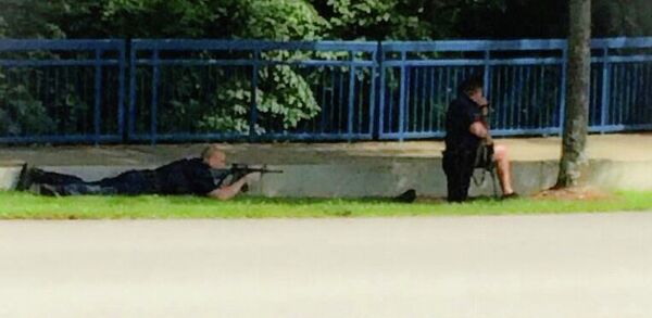 In this image made from video and released by WRCB-TV, authorities work an active shooting scene on amincola highway near the Naval Reserve Center, in Chattanooga, Tenn. on Thursday, July 16, 2015 - Sputnik International