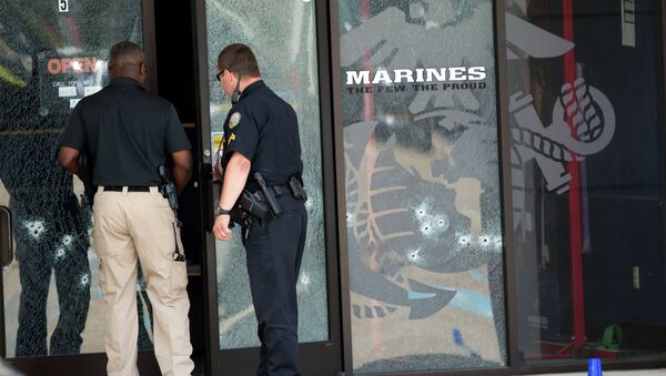 Police officers enter the Armed Forces Career Center through a bullet-riddled door after a gunman opened fire on the building Thursday, July 16, 2015, in Chattanooga, Tenn. - Sputnik International