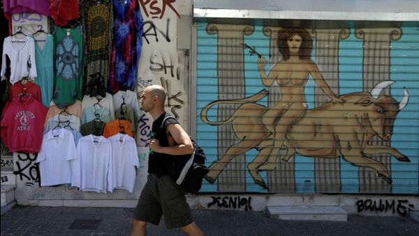 A pedestrian passes a graffiti depicting, the Greek mythological story about the abduction of the Phoenician maiden named Europa by the Olympian god Zeus in the form of a bull, in a symbolic depiction of what some see as the European crisis, at the shutter of a closed shop at Monastiraki tourist district in Athens, Monday, May 25, 2015 - Sputnik International