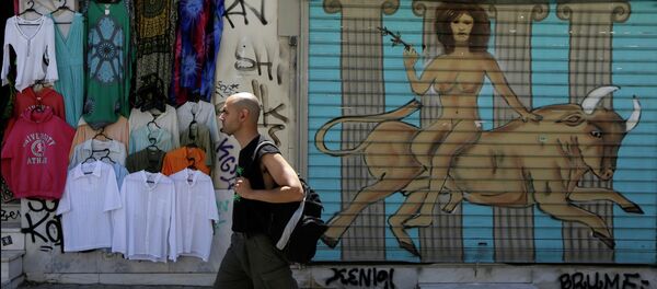 A pedestrian passes a graffiti depicting, the Greek mythological story about the abduction of the Phoenician maiden named Europa by the Olympian god Zeus in the form of a bull, in a symbolic depiction of what some see as the European crisis, at the shutter of a closed shop at Monastiraki tourist district in Athens, Monday, May 25, 2015 A pedestrian passes a graffiti depicting, the Greek mythological story about the abduction of the Phoenician maiden named Europa by the Olympian god Zeus in the form of a bull, in a symbolic depiction of what some see as the European crisis, at the shutter of a closed shop at Monastiraki tourist district in Athens, Monday, May 25, 2015 - Sputnik International