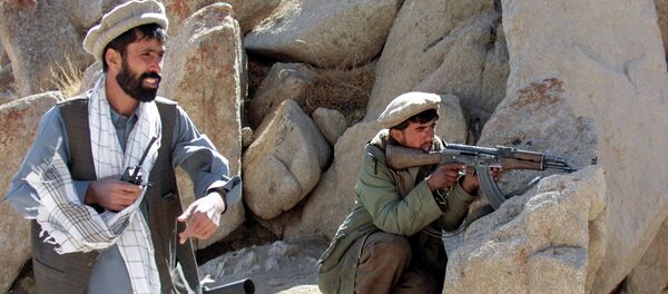 An Afghan anti-Taliban Northern Alliance soldier shoots at positions held by the ruling religious militia close to the strategically important Salang heights, around 100 kms north of the capital Kabul, 26 September 2001, under the orders of his commander An Afghan anti-Taliban Northern Alliance soldier shoots at positions held by the ruling religious militia close to the strategically important Salang heights, around 100 kms north of the capital Kabul, 26 September 2001, under the orders of his commander - Sputnik International
