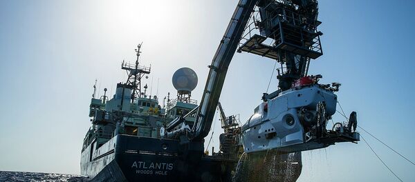 In this image released by, The Woods Hole Oceanographic Institution, the research vessel Atlantis is shown off the coast of the Carolinas in the Atlantic Ocean during the second week of July 2015 with the submersible Alvin hanging off its stern - Sputnik International