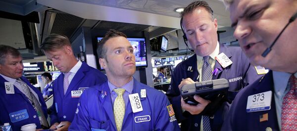 Traders Frank Masiello, center, and John Panin, right, talk about stock prices at the New York Stock Exchange, Tuesday, July 14, 2015 - Sputnik International