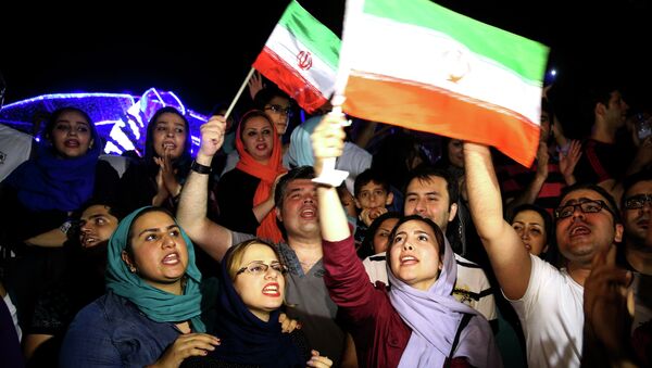 Jubilant Iranians sing and wave Iran flags during street celebrations following a landmark nuclear deal, in Tehran, Iran, Tuesday, July 14, 2015 - Sputnik International