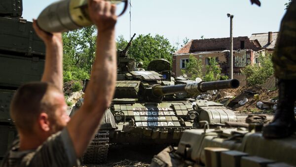 Member of the self-proclaimed Donetsk People's Republic forces loads shells in a tank at Donetsk airport, eastern Ukraine, Friday, June 12, 2015 - Sputnik International