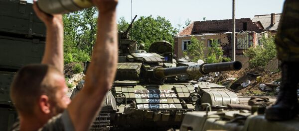Member of the self-proclaimed Donetsk People's Republic forces loads shells in a tank at Donetsk airport, eastern Ukraine, Friday, June 12, 2015 Member of the self-proclaimed Donetsk People's Republic forces loads shells in a tank at Donetsk airport, eastern Ukraine, Friday, June 12, 2015 - Sputnik International
