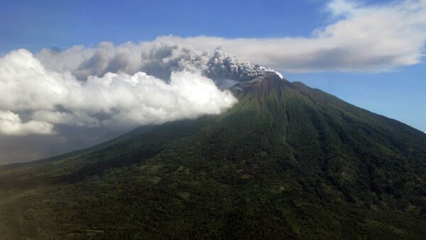 In this Sunday, Sept. 16, 2012 aerial shot, Mount Gamalama spews volcanic ash as it erupts on Ternate Island, eastern Indonesia - Sputnik International