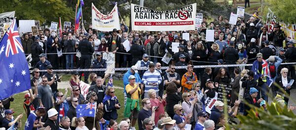 Opposing protest groups, from the Reclaim Australia anti-islam group (foreground) and those calling for an end to racism (background) are separated by a police line in Brisbane, July 19, 2015 Opposing protest groups, from the Reclaim Australia anti-islam group (foreground) and those calling for an end to racism (background) are separated by a police line in Brisbane, July 19, 2015 - Sputnik International
