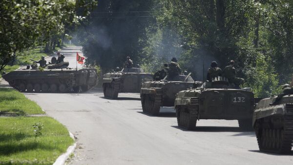 Members of the self-proclaimed Donetsk People's Republic forces ride on armoured personnel carriers (APC) near the urban settlement of Zaytsevo in Donetsk region, Ukraine, July 20, 2015 - Sputnik International