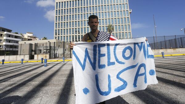 A man hold a banner in front of the U.S. Interests Section in Havana July 20, 2015 - Sputnik International