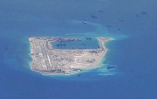 Chinese dredging vessels are purportedly seen in the waters around Fiery Cross Reef in the disputed Spratly Islands in the South China Sea in this still file image from video taken by a P-8A Poseidon surveillance aircraft provided by the United States Navy Chinese dredging vessels are purportedly seen in the waters around Fiery Cross Reef in the disputed Spratly Islands in the South China Sea in this still file image from video taken by a P-8A Poseidon surveillance aircraft provided by the United States Navy - Sputnik International