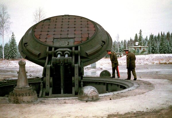 Russian high ranking military officials, look into an opened silo of a Russian intercontinental ballistic Topol-M missile somewhere at undisclosed location in Russia in this 2001 photo - Sputnik International