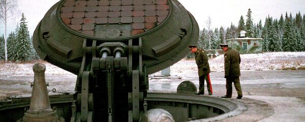 Russian high ranking military officials, look into an opened silo of a Russian intercontinental ballistic Topol-M missile somewhere at undisclosed location in Russia in this 2001 photo - Sputnik International