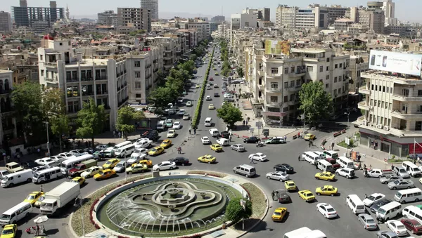 A general view shot taken on June 30, 2015, shows traffic on a roundabout in the Syrian capital Damascus - Sputnik International