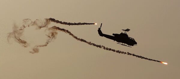 A Cobra attack helicopter fires diversionary flares. - Sputnik International