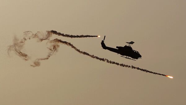 A Cobra attack helicopter fires diversionary flares. - Sputnik International