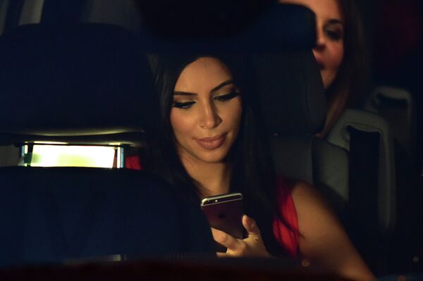 US reality TV star Kim Kardashian looks at her iPhone as she sits in a car after visiting the genocide memorial, which commemorates the 1915 mass killing of Armenians in the Ottoman Empire, in Yerevan on April 10, 2015 US reality TV star Kim Kardashian looks at her iPhone as she sits in a car after visiting the genocide memorial, which commemorates the 1915 mass killing of Armenians in the Ottoman Empire, in Yerevan on April 10, 2015 - Sputnik International