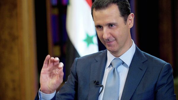 In this Tuesday, Feb. 10, 2015 file photo released by the Syrian official news agency SANA, Syrian President Bashar Assad gestures during an interview with the BBC, in Damascus, Syria - Sputnik International