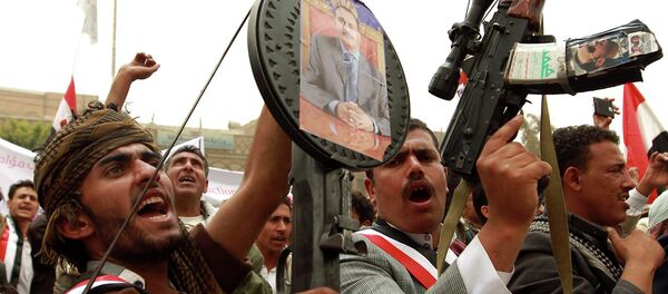 Yemeni protesters hold rifels with portraits of Yemen's former president Ali Abdullah Saleh hung on them during a demonstration against airstrikes carried out by the Saudi-led Arab coalition against Huthi militia in the capital Sanaa on April 3, 2015 Yemeni protesters hold rifels with portraits of Yemen's former president Ali Abdullah Saleh hung on them during a demonstration against airstrikes carried out by the Saudi-led Arab coalition against Huthi militia in the capital Sanaa on April 3, 2015 - Sputnik International