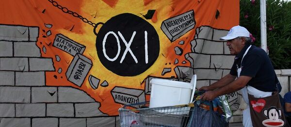 A street vendor pushes his trolley as he passes a banner, depicting a wrecking ball that reads: NO and destroying a wall with anti-austerity measures, in Athens, Wednesday, July 22, 2015. A street vendor pushes his trolley as he passes a banner, depicting a wrecking ball that reads: NO and destroying a wall with anti-austerity measures, in Athens, Wednesday, July 22, 2015. - Sputnik International