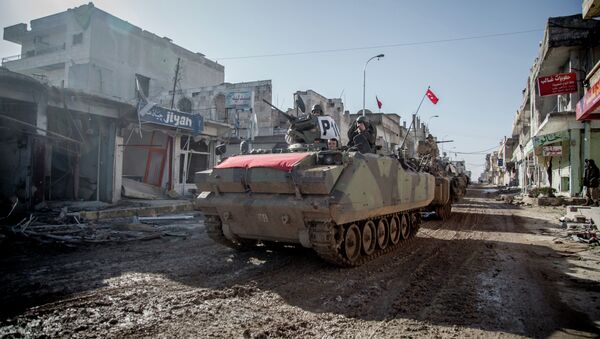 Turkish army vehicles drive in a street of the Syrian town of Kobane (aka Ain al-Arab) on February 22, 2015 - Sputnik International