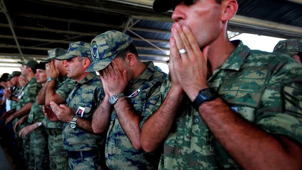 Turkish soldiers pray during the funeral of slain soldier Mehmet Yalcin Nane, killed Thursday by IS militants when they attacked a Turkish military outpost at the border with Syria, in the town of Gaziantep, southeastern Turkey, Friday, July 24, 2015. - Sputnik International