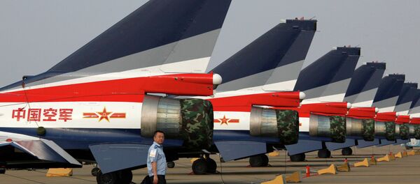 A man walks pasT the Chinese-made J-10 jet fighters on display at the 8th China International Aviation and Aerospace Exhibition (Zhuhai Airshow) in Zhuhai. A man walks pasT the Chinese-made J-10 jet fighters on display at the 8th China International Aviation and Aerospace Exhibition (Zhuhai Airshow) in Zhuhai. - Sputnik International