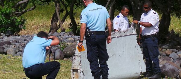 French gendarmes and police inspect a large piece of plane debris which was found on the beach in Saint-Andre French gendarmes and police inspect a large piece of plane debris which was found on the beach in Saint-Andre - Sputnik International