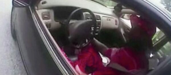 In this July 19, 2015 file photo from a body camera video provided by the University of Cincinnati Campus Police, university Officer Ray Tensing stands next to motorist Samuel DuBose during a traffic stop for a missing front license plate in Cincinnati. DuBose was fatally shot by the officer after a struggle ensued when he refused to provide a driver's license and get out of the car. Tensing was indicted Wednesday, July 29 on a murder charge. In this July 19, 2015 file photo from a body camera video provided by the University of Cincinnati Campus Police, university Officer Ray Tensing stands next to motorist Samuel DuBose during a traffic stop for a missing front license plate in Cincinnati. DuBose was fatally shot by the officer after a struggle ensued when he refused to provide a driver's license and get out of the car. Tensing was indicted Wednesday, July 29 on a murder charge. - Sputnik International